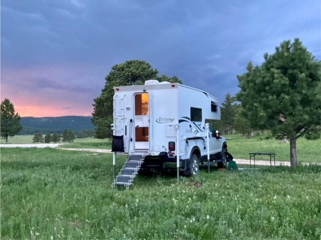 Northstar camper in a field at sunset